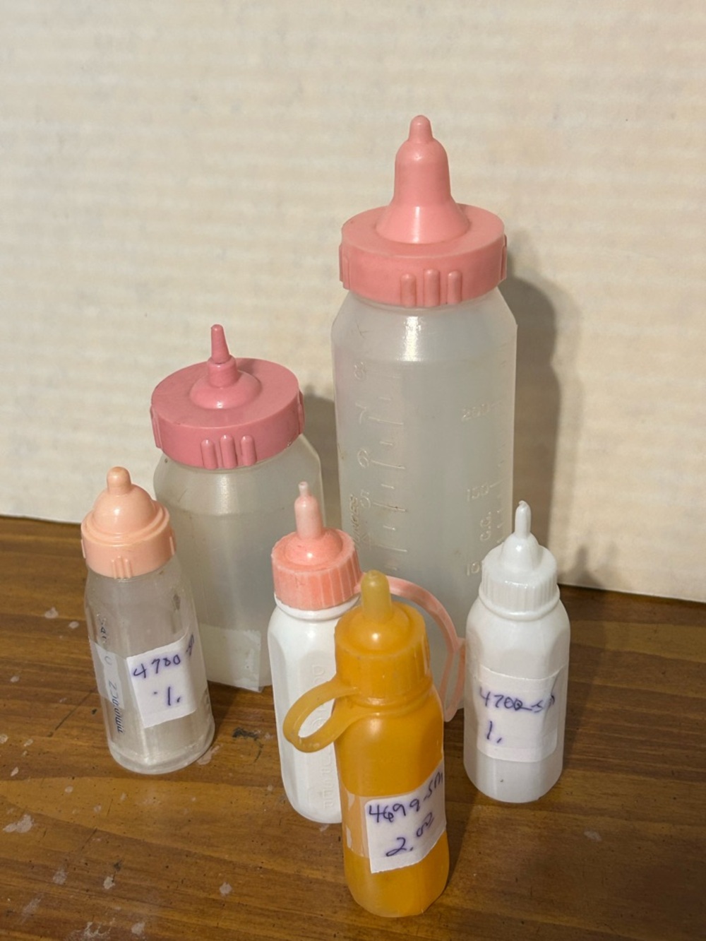 Assorted Vintage Plastic Baby Bottles - Pink, White, Yellow